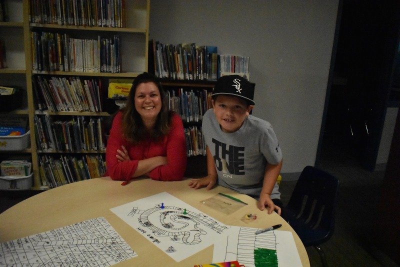 Kellon with his board game he created.